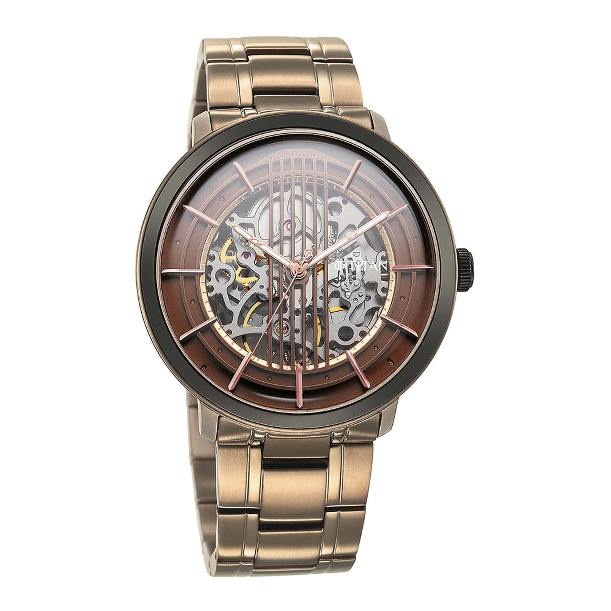 Skeleton brown dial with Titan Quartet automatic watch, paired with a champagne-toned steel strap.