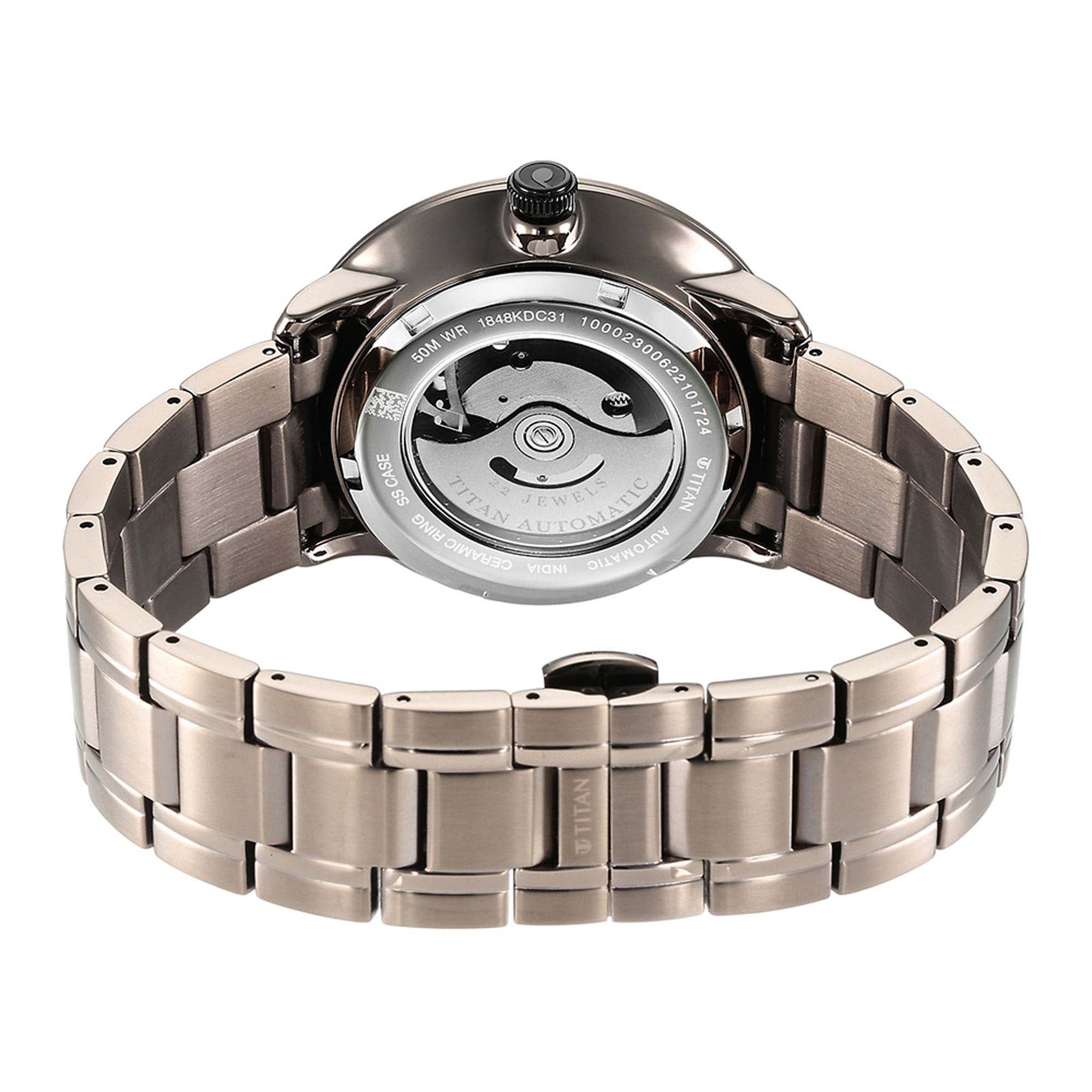 Rear caseback reveals Titan Quartet automatic watch movement with exhibition window and steel strap.