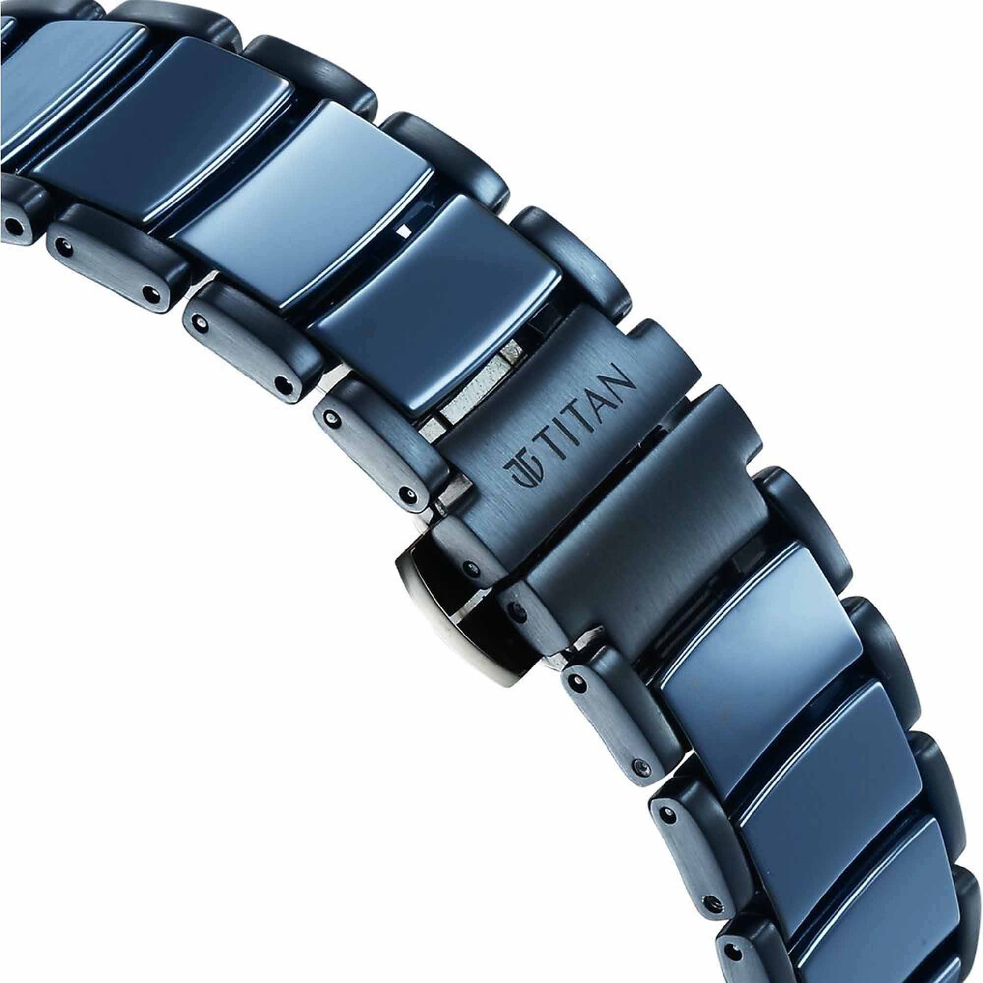 Close-up of Titan Edge analog watch steel ceramic strap with brushed blue links and engraved clasp.