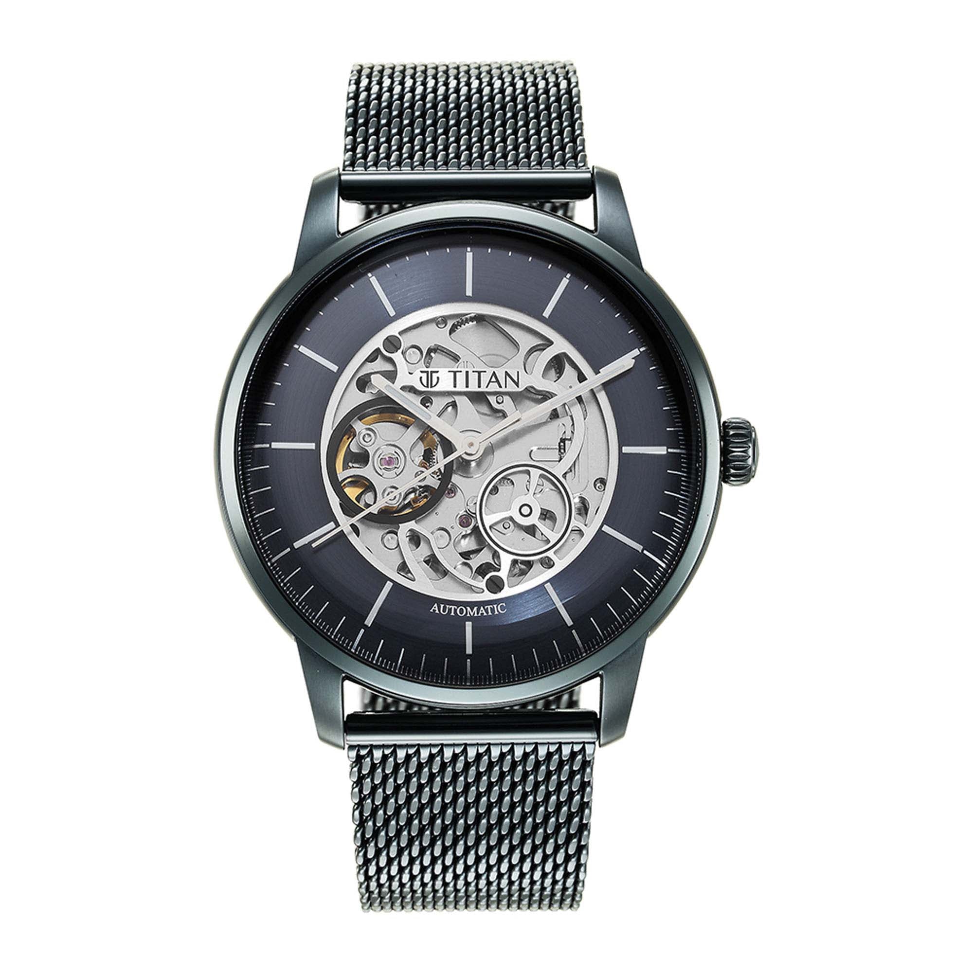 Striking Titan mechanical watch with blue dial skeleton design & stainless steel mesh strap for men.