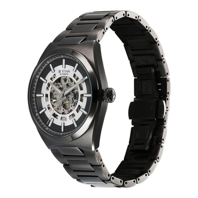 Angled view of black Titan Nexus skeletal automatic analog watch for men with stainless steel strap.