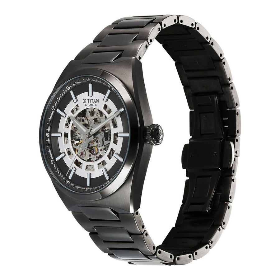 Angled view of black Titan Nexus skeletal automatic analog watch for men with stainless steel strap.