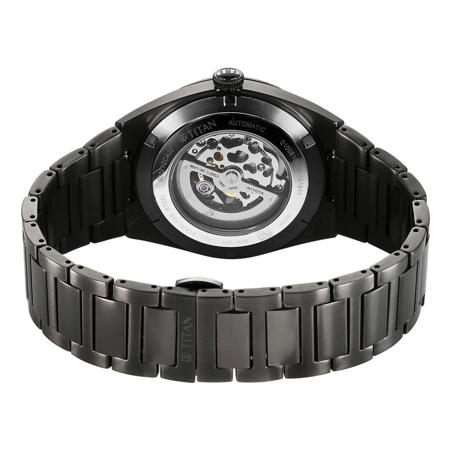 Rear view reveals a Titan automatic analog watch for men with a transparent case back & steel strap.