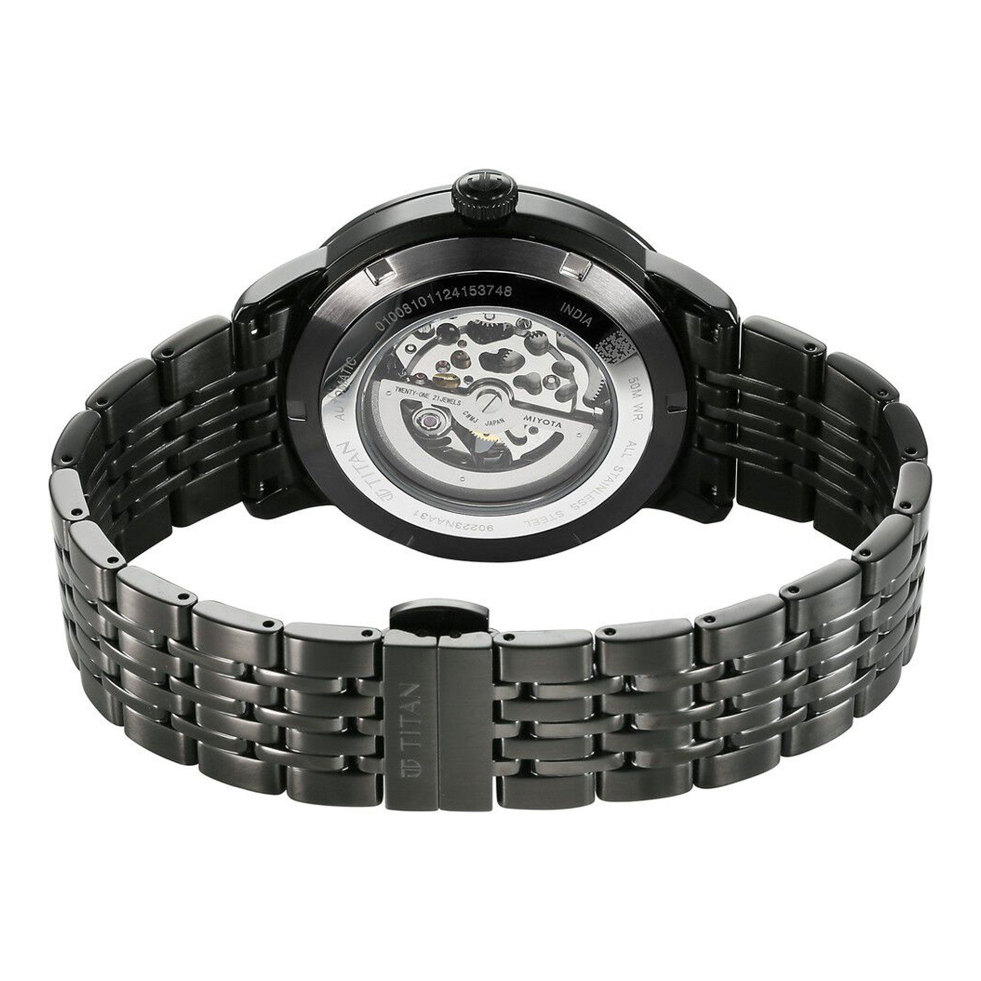 Rear view shows Titan Phoenix automatic analog watch with transparent case back & black steel strap.